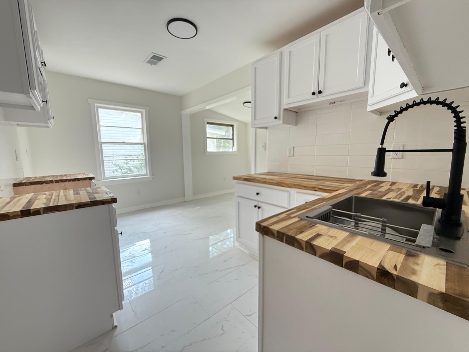 Kitchen sink with butcher-block counters and matte black faucet in a Stellar-managed home